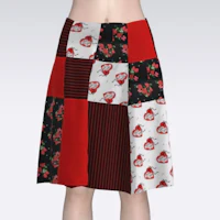 a woman wearing a red and black patchwork skirt