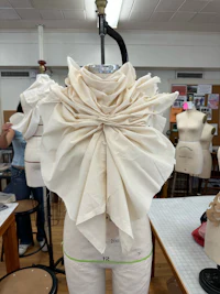 a mannequin with a white bow on it