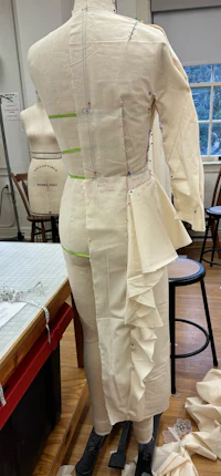 a mannequin with a ruffled skirt on a table